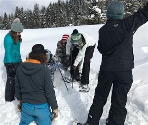 Hunting for an avalanche beacon during avalanche training at Lolo Pass 